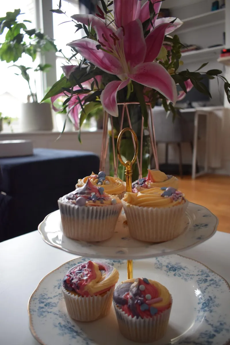 Pastel swirl cupcakes with sprinkles on a vintage two-tier stand